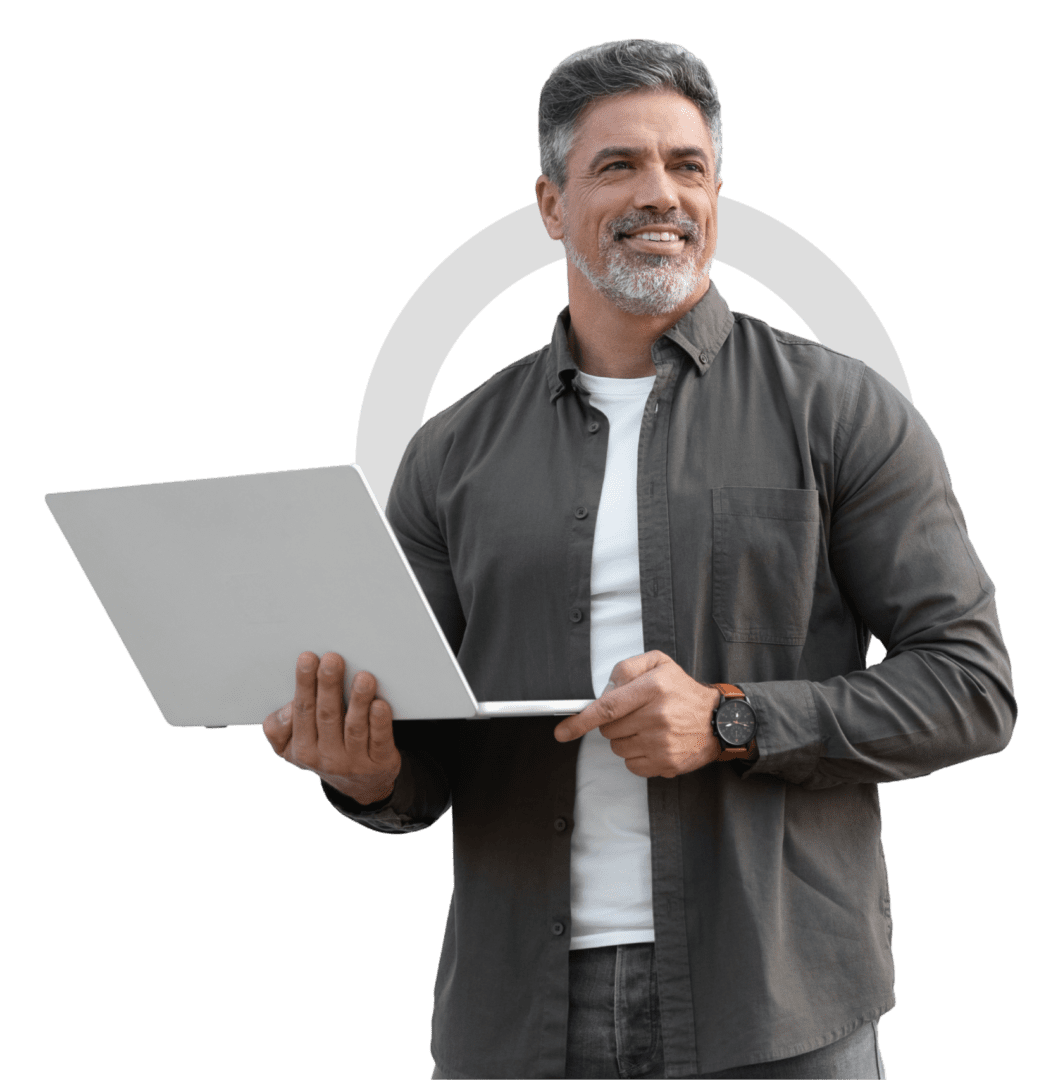 Man holding laptop, smiling confidently.